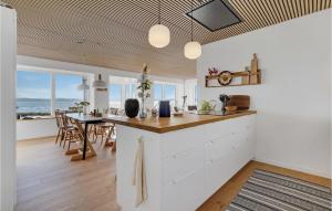 a kitchen and dining room with a view of the ocean at Lovely Home In Fredericia With House Sea View in Fredericia