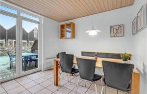 a kitchen with a table and chairs and a dining room at Cozy Home In Nrre Nebel With Kitchen in Nørre Nebel