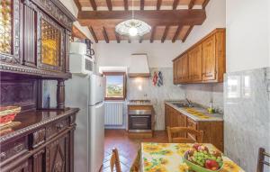 a kitchen with a table with a bowl of fruit on it at Beautiful Home In Castiglion Fiorentino With Kitchen in Pergognano