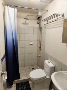 a small bathroom with a toilet and a sink at Manila Condo in front of Rizal Park Taft Ave LRT UN Station Unli WiFi Netflix Disney Youtube by 24K Residences in Manila