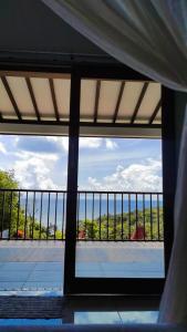 a view of a balcony from a room with a window at Mirabelle Joglo Village in Karimunjawa