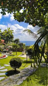 a garden with the ocean in the background at Mirabelle Joglo Village in Karimunjawa