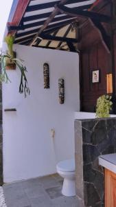 a bathroom with a toilet in a building at Mirabelle Joglo Village in Karimunjawa