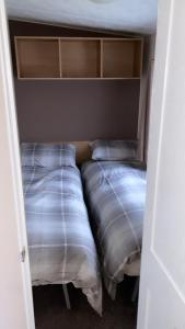 two beds in a small room with at Golden sands holiday park- pitch H84 in Cockwood