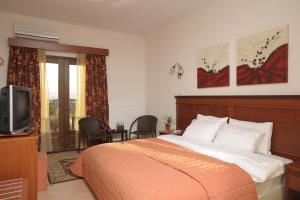 Ένα ή περισσότερα κρεβάτια σε δωμάτιο στο Ξενώνας Ολυμπία