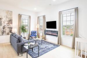 a living room with a couch and a tv at Upscale Loft Downtown NOLA 2835 in New Orleans