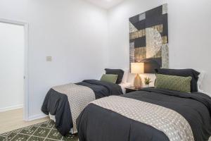 a bedroom with two beds and a wall at Upscale Loft Downtown NOLA 2835 in New Orleans