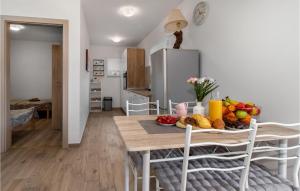 a kitchen and dining room with a table with fruit on it at 2 Bedroom Gorgeous Apartment In Viskovo in Viskovo