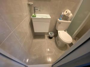 a small bathroom with a toilet and a sink at Ocean pearl 2 in San Juan