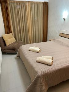 a bedroom with a bed with two towels on it at Hillside Bakuriani in Bakuriani
