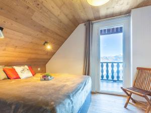 a bedroom with a large window and a bed with a chair at Chalet typique rénové à Soulan, 4 chambres, 9 pers. - FR-1-296-349 in Saint-Lary-Soulan