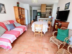 a living room with a couch and a table at Appartement Six-Fours-les-Plages, 3 pièces, 6 personnes - FR-1-316-122 in Six-Fours-les-Plages