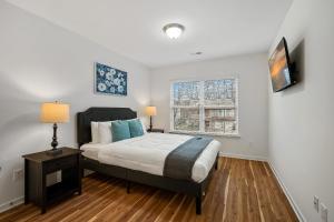 a bedroom with a large bed and a window at Stylish 4B 3B -King Bed- Jacuzzi in Charlotte