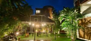 a house with a table in the yard at night at BRICK CASTLE in Chennai