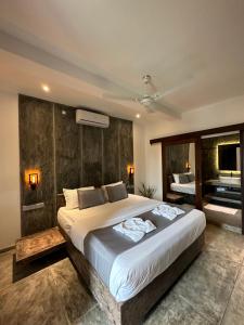 a bedroom with a large bed and a television at Ami Mirissa in Mirissa