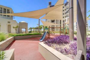 a patio with a swing and a canopy at Fantastic View l 2BR l Fully Equipped in Dubai