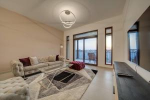 a living room with a couch and a table at Fantastic View l 2BR l Fully Equipped in Dubai