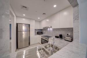 a kitchen with a stainless steel refrigerator and a sink at Fantastic View l 2BR l Fully Equipped in Dubai