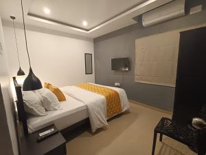 a bedroom with a bed and a tv in it at BRICK CASTLE in Chennai