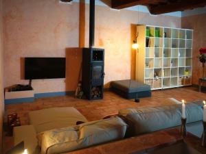a living room with couches and a flat screen tv at Polvereto in Le Fornacette