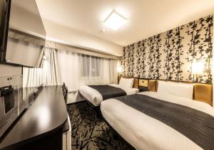 Letto o letti in una camera di APA Hotel & Resort Osaka Umeda Eki Tower