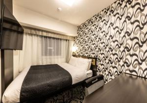Letto o letti in una camera di APA Hotel & Resort Osaka Umeda Eki Tower