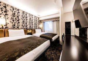 Letto o letti in una camera di APA Hotel & Resort Osaka Umeda Eki Tower