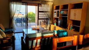 a kitchen with a table and a view of a patio at Tiny's Getaway in Jeffreys Bay
