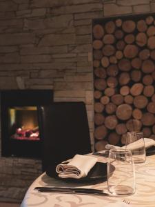 a table with a laptop computer on a table with a fireplace at Hiša Aleš in Kranj