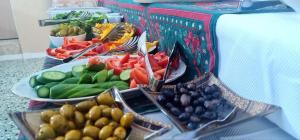 a buffet of fruits and vegetables on a table at Aida Guest house in Nazareth