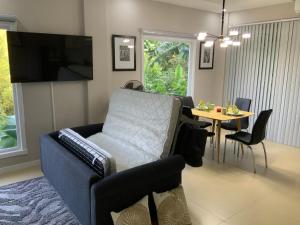 a living room with a blue couch and a table at Casa de Simone in Bagac