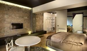 a bedroom with a bed and a table and a tv at Nuru Ziya Suites in Istanbul