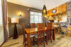 a kitchen and dining room with a wooden table and chairs at Beachfront Tamarin Villa in Tamarin