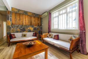 a living room with two couches and a table at Beachfront Tamarin Villa in Tamarin +14 photos