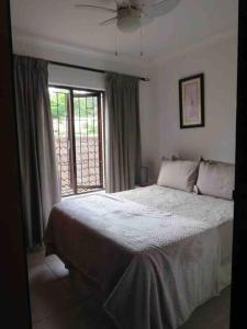 a bedroom with a large bed and a window at Surabaya 21 in Margate