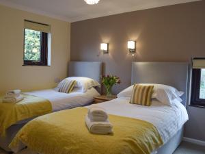 a bedroom with two beds with towels on them at The Old Coach House in Hayscastle