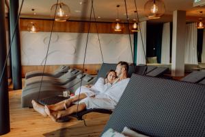 a man and a woman sitting on a couch at Ratscher Landhaus in Ratsch an der Weinstraße