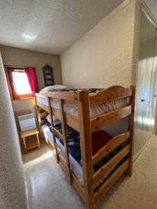 a bedroom with two bunk beds in a room at Appartement ensoleillé Lanslevillard station Val Cenis Vanoise in Lanslevillard