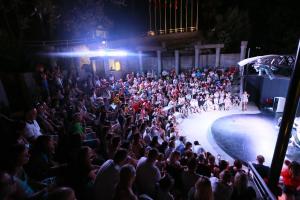 a crowd of people watching a fashion show on a stage at Turunc Resort Hotel in Turunc