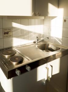 a kitchen with a stainless steel stove and a sink at Cochs Pensjonat in Oslo