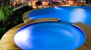 a large blue swimming pool on top of a building at One bed Harbour and city views apartment in Darwin