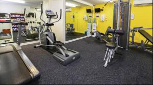 a gym with several treadmills and cardio machines at One bed Harbour and city views apartment in Darwin
