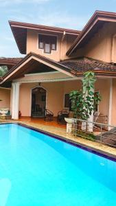 a house with a swimming pool in front of it at Sky Valley in Kandy