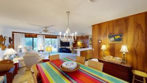 a living room with a table and a dining room at ALMOST HEAVEN home in Jekyll Island