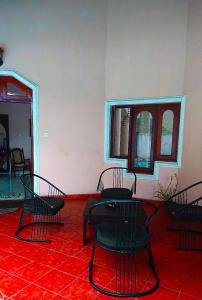 a room with black chairs and a red floor at Sky Valley in Kandy