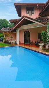 a large blue swimming pool in front of a house at Sky Valley in Kandy