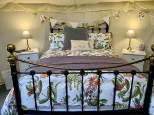 a bedroom with a bed with a canopy at Bramble Lodge Glamping in Louth