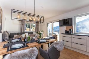 a dining room with a table and some chairs at Lienbichl in Saalbach Hinterglemm