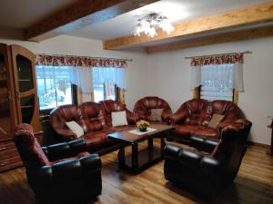 a living room with leather couches and a table at ChatkaDuraje in Jaworzynka
