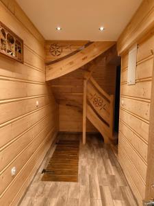 a sauna with wooden walls and wooden flooring at ChatkaDuraje in Jaworzynka